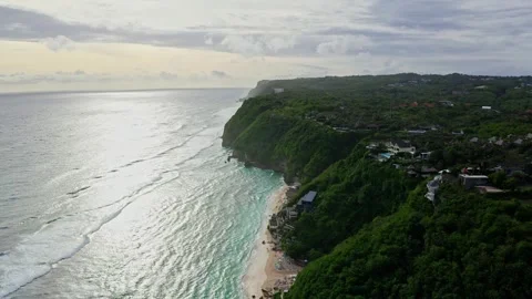 Drone view over the cliff and shore with wave and sunset in Bali, 2K Stock Footage 246163141