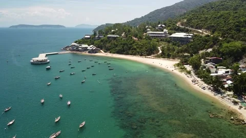 Drone view over coastal beach in a tropical island with boats floating on water. Stock Footage 146825293