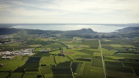Drone View over Fields and Roads with Lake Garda and Garda Town, Italy Video stock 316761003
