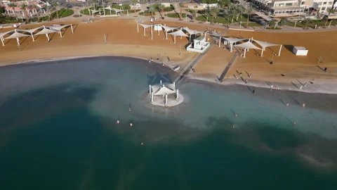 Drone view over gazebos on the Ein Bokek beach during daytime Stock Footage 242176449