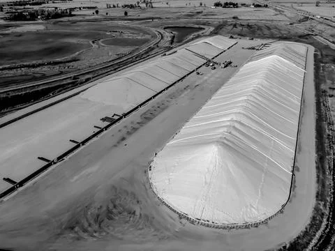 Drone view over grain storage piles being filled and covered Stock Photos