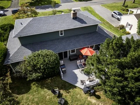 Drone view from over a house of a backyard deck set up for a party Stock Photos