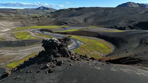 Drone view over Icelandic highlands with a winding river cutting through bright Stock Footage 332370274