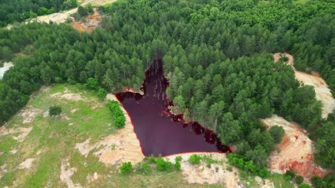 Drone view over Red Lake to the village of Elshitsa Bulgaria Stock Footage 256031550