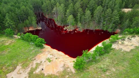 Drone view over Red Lake to the village of Elshitsa Bulgaria Stock Footage 256031859