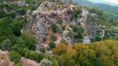 Drone view over Rock tombs of Pinara ancient city in Lycia, Antalya, Turkey	 Stock Footage 231240896