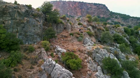 Drone view over Rock tombs of Pinara ancient city in Lycia, Antalya, Turkey	 Stock Footage 231241432