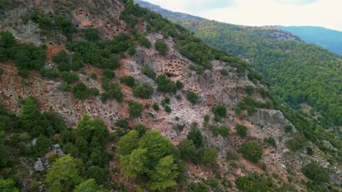 Drone view over Rock tombs of Pinara ancient city in Lycia, Antalya, Turkey	 Stock Footage 231241856
