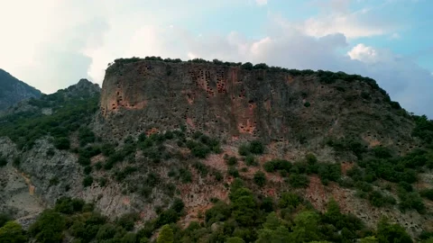 Drone view over Rock tombs of Pinara ancient city in Lycia, Antalya, Turkey	 Stock Footage 231241999