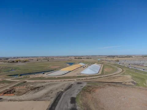 Drone view over two grain storage piles being filled and covered Foto stock