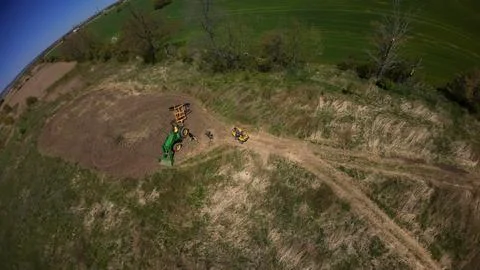 Drone view of a parked tractor and an ATV beside a food plot Stock-Fotos