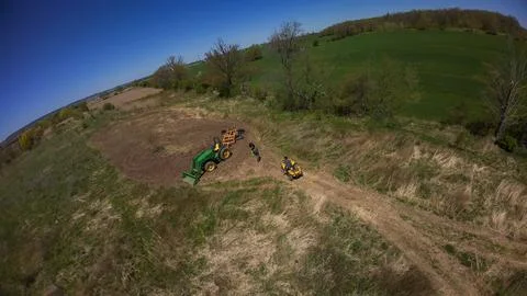 Drone view of a parked tractor and an ATV beside a food plot Stock-Fotos