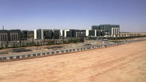Drone view passing modern offices beside a Riyadh work site 库存影片 346430515