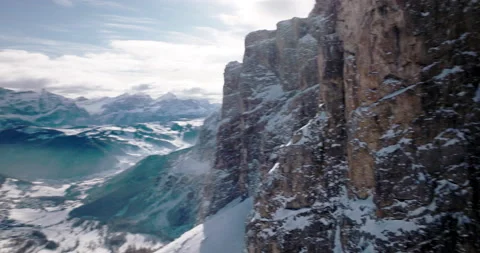 Drone view passing rock wall in winter 5k Stock Footage 221903315