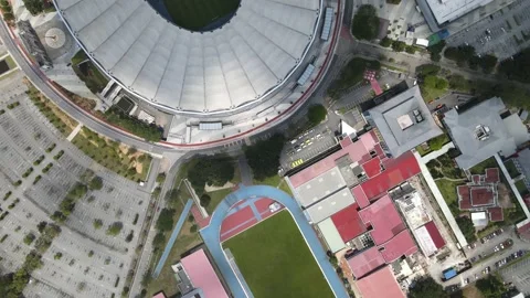 Drone view passing through Parking Lot, Field, National Stadium and Office Stock Footage 148426511