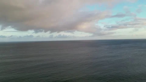 Drone view of pastel clouds above the calm Pacific at dusk in Hawaii 動画素材 348251052
