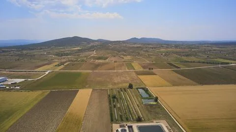 Drone view of patchwork farmland with hills and reservoirs Stock Photos