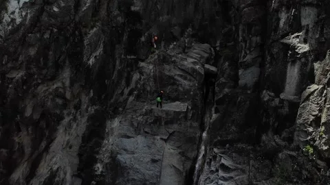 Drone view of people abseiling and canyoning. Aerial view of abseiling down a Stock Footage 201525204