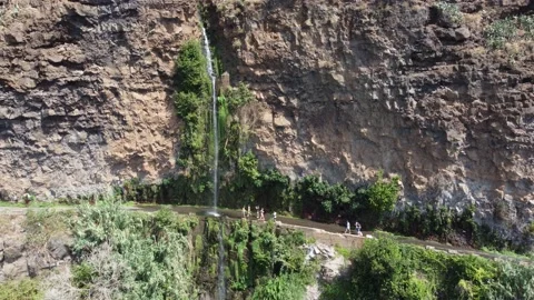 Drone view of people bathing on a high waterfall falling on the road Stock Footage 171557964