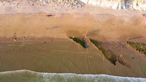 Drone view of people on the beach during a beautiful sunset. Stock Footage 180410363