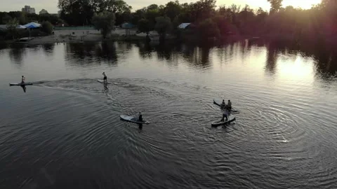 Drone view of people floating on a sub board on a blue lake Stock Footage 155999959