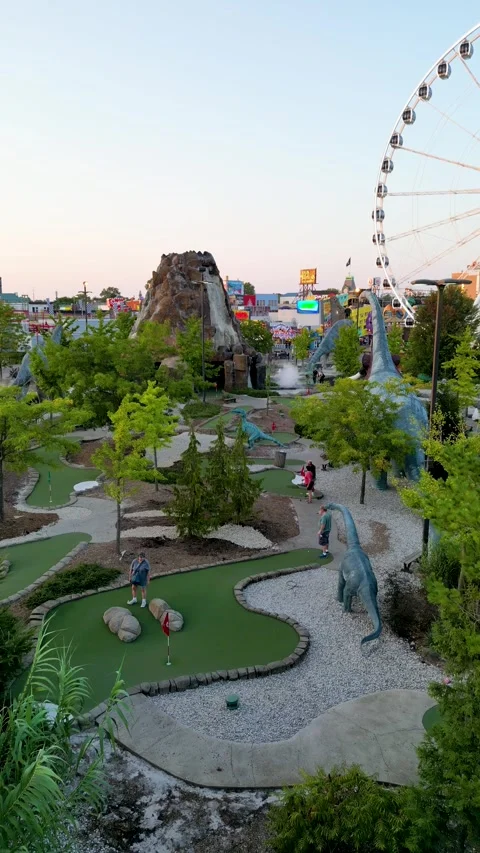 Drone View of People Playing Mini Golf Among Dinosaur Statues on Clifton Hill, Stock-Footage 330450803