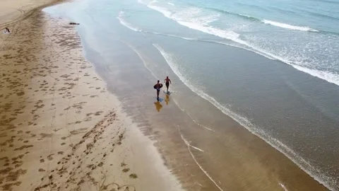 The drone view of people playing skimboard at the beach. Stock Footage 221354726