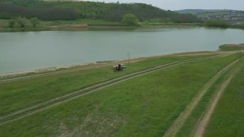 Drone View of People Resting Beside Lakeside Trail in Countryside Stock Footage 341763086