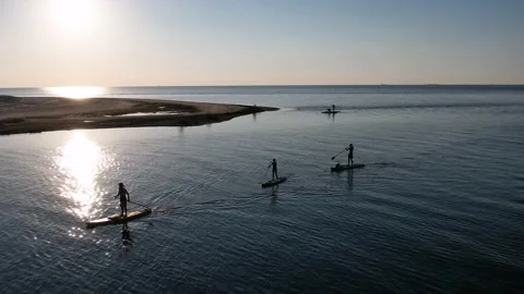 Drone view of people riding on SUP Board at sunset Video stock 199805925