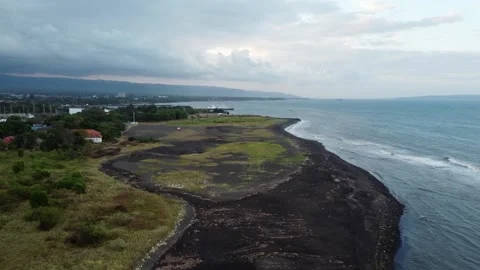 Drone view of plastic waste washed ashore on a black volcanic sand coastlin 库存影片 341313726