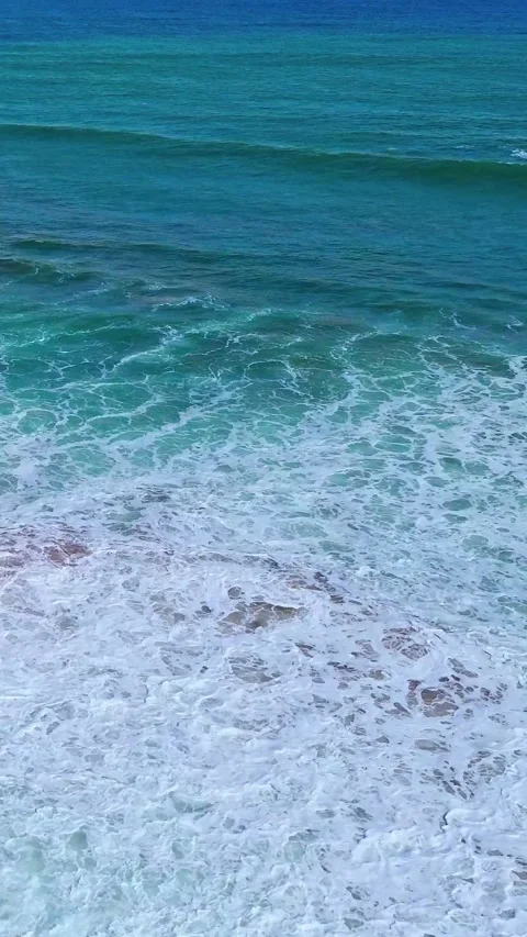 Drone View of Powerful Ocean Waves Crashing and Rushing Shoreline Stock Footage 315094905