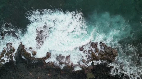 Drone view of powerful waves crashing on black lava rocks in Hawaii Stock-Footage 347825864