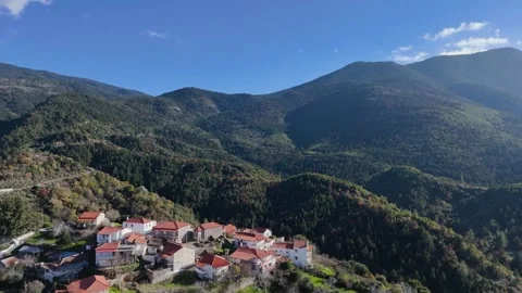 Drone view pulling away from village into wide mountain landscape Stock-Footage 331187427