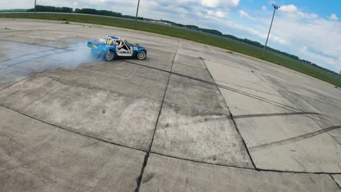 Car drift skid marks on empty parking lot, aerial drone top view