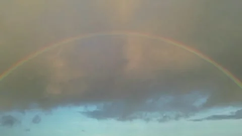 Drone view of a rainbow arching over dark clouds in Hawaii Stock-Footage 347825830