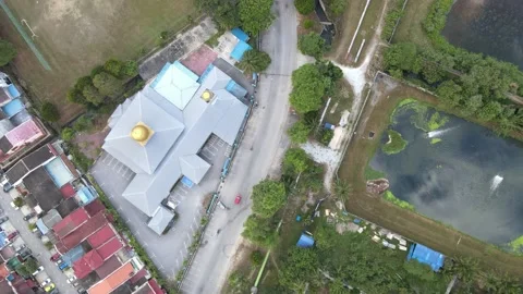 Drone view of a Red Car moving and roof top of the Mosque during MCO Stock Footage 148496400