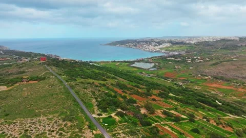 Drone view of Red tower and long road. Maltese island, sea, green nature Stock Footage 329372170