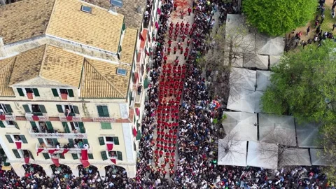 Drone View of Red Uniform Philharmonic Band Parading Through Crowd in Corfu Stock Footage 333819756