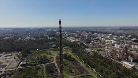 Drone view of refinery tanks with active flare stack, daytime Video stock 316214373