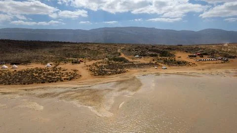 Drone view of remote desert beach campsite and tidal flats. Detwah Lagoon, .. Stock-Fotos