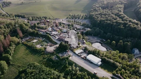 Drone view of resort with ferris wheel in the hills in sunny weather Video stock 196837022