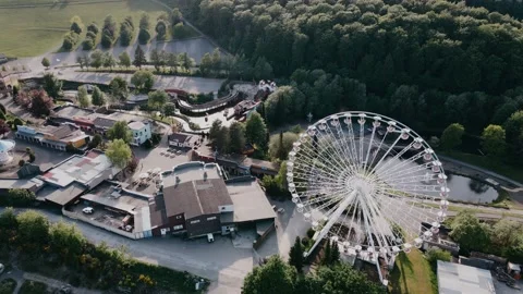 Drone view of resort with ferris wheel in the hills in sunny weather Video stock 196837500