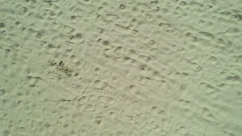 Drone view from rising up camera sandy beach frozen sea ocean bay on a sunny day Stock Footage 186097598