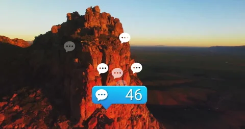 Drone view rising over sandstone cliff, chat-bubble count incrementing to Stock Footage 312714026