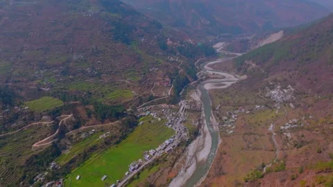 Drone view of river flowing between the mountains and some beautiful villag.. Stock Footage 307675916