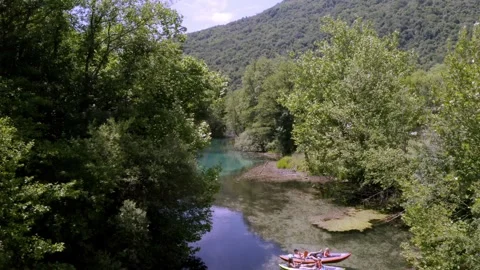 Drone view a river with two canoes near to a forest Stock Footage 263889649