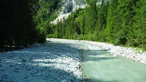 Drone view of river, white stone beach, forest, and quarry mountain Stock Footage 314195742