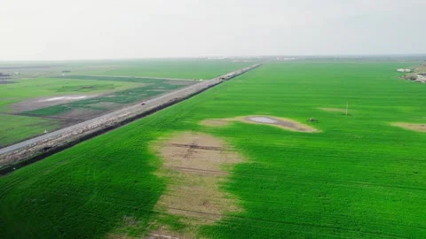 Drone view of a road between green fields Video stock 272993968