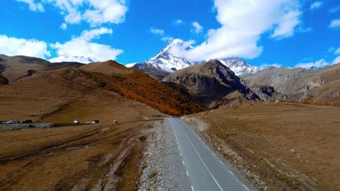 Drone view of road leading to famous scenery Mount Kazbegi Stock Footage 224909077