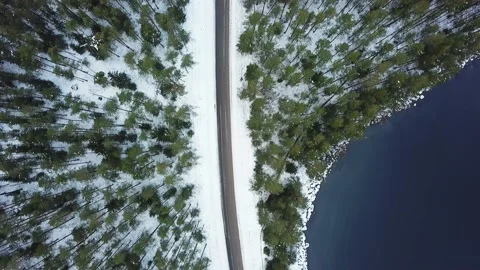 Drone View of Road with Snow in Forest, next to Lake – Top Down Winter Scene Stock-Footage 146608168